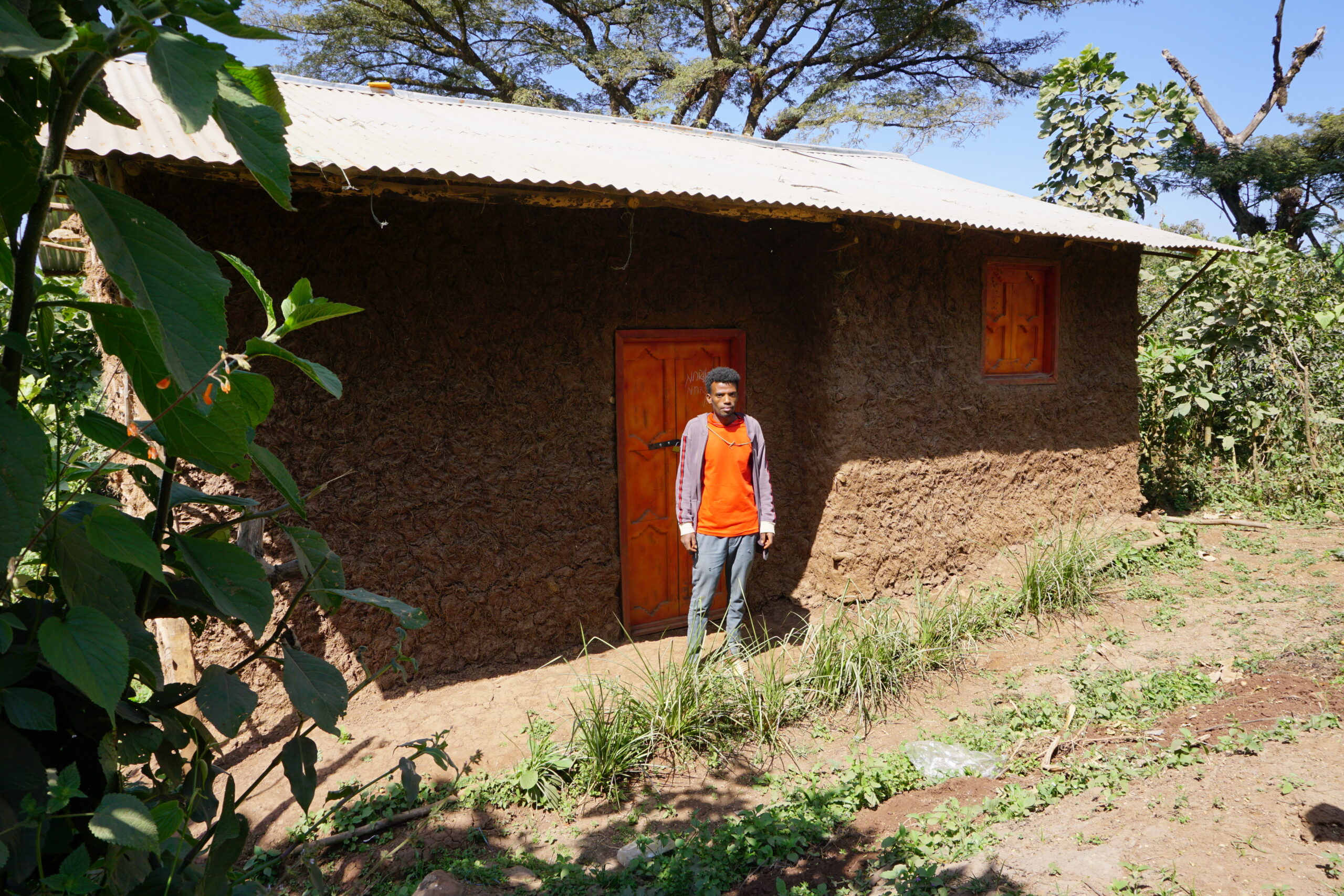 Mohammed Jemal standing in front of his newly built house in Seko, Ethiopia