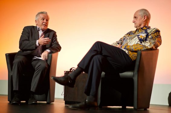 Two men in easy chairs engage in conversation