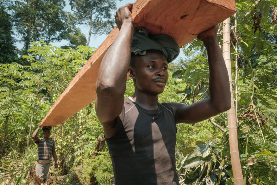 Men carrying plank of wood