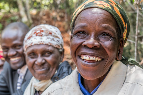 A smiling woman's face, with two men's faces also in the frame
