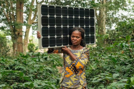 Woman carries a solar panel