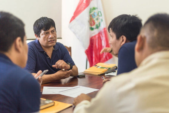 Men engage in discussion at a table