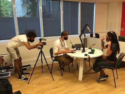 People are filming at a table