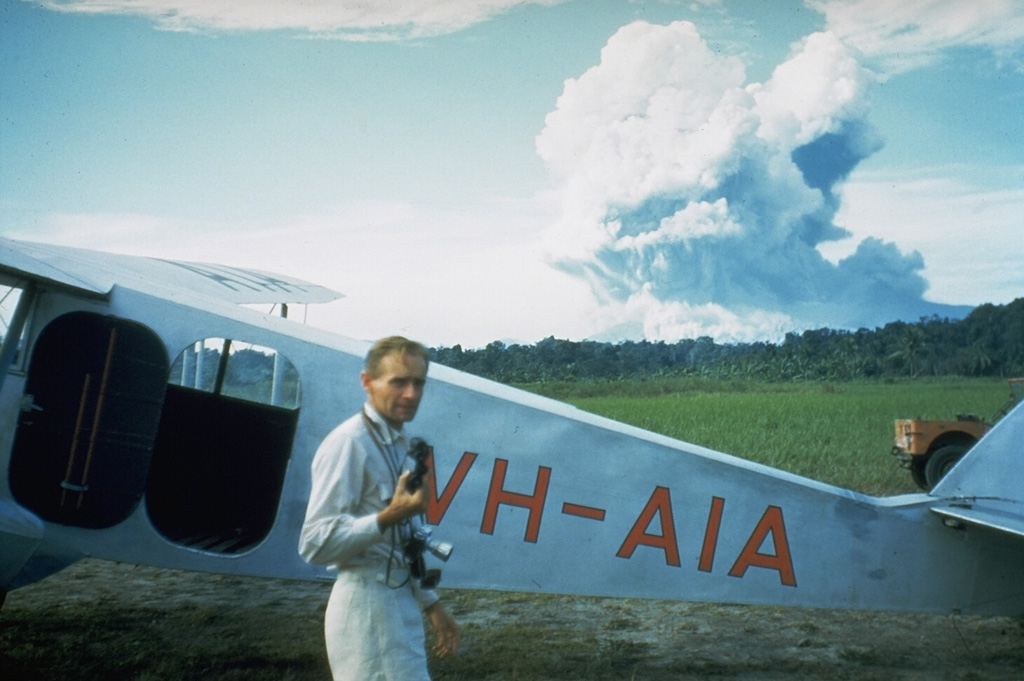 Volcanologist Tony Taylor with aircraft in foreground during the 1951 Mount Lamington eruption in Papua New Guinea.