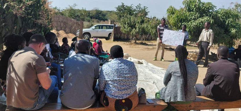 In Malawi, Mr and Mrs Mathambo present their household vision under mango trees to a delegation, illustrating women empowerment in food tree value chains