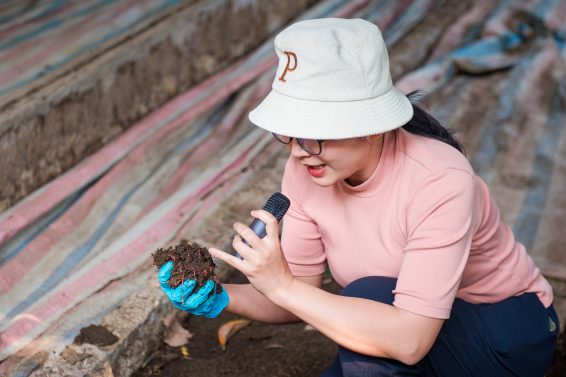 Researcher analysing soil health during a field visit in Vietnam, symbolising progress in agroecology through applied science and collaboration.