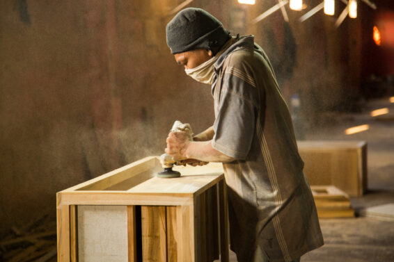 A worker sands a wooden product in a workshop in Yogyakarta, Indonesia.