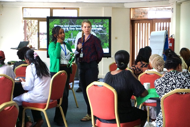 Facilitators Beliyu Limenih and Katrine Friborg speak with participants during a workshop session on leadership and gender.