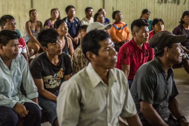 Community members attend a REDD+ workshop in La Roya, Ucayali, Peru, where researchers present their findings.
