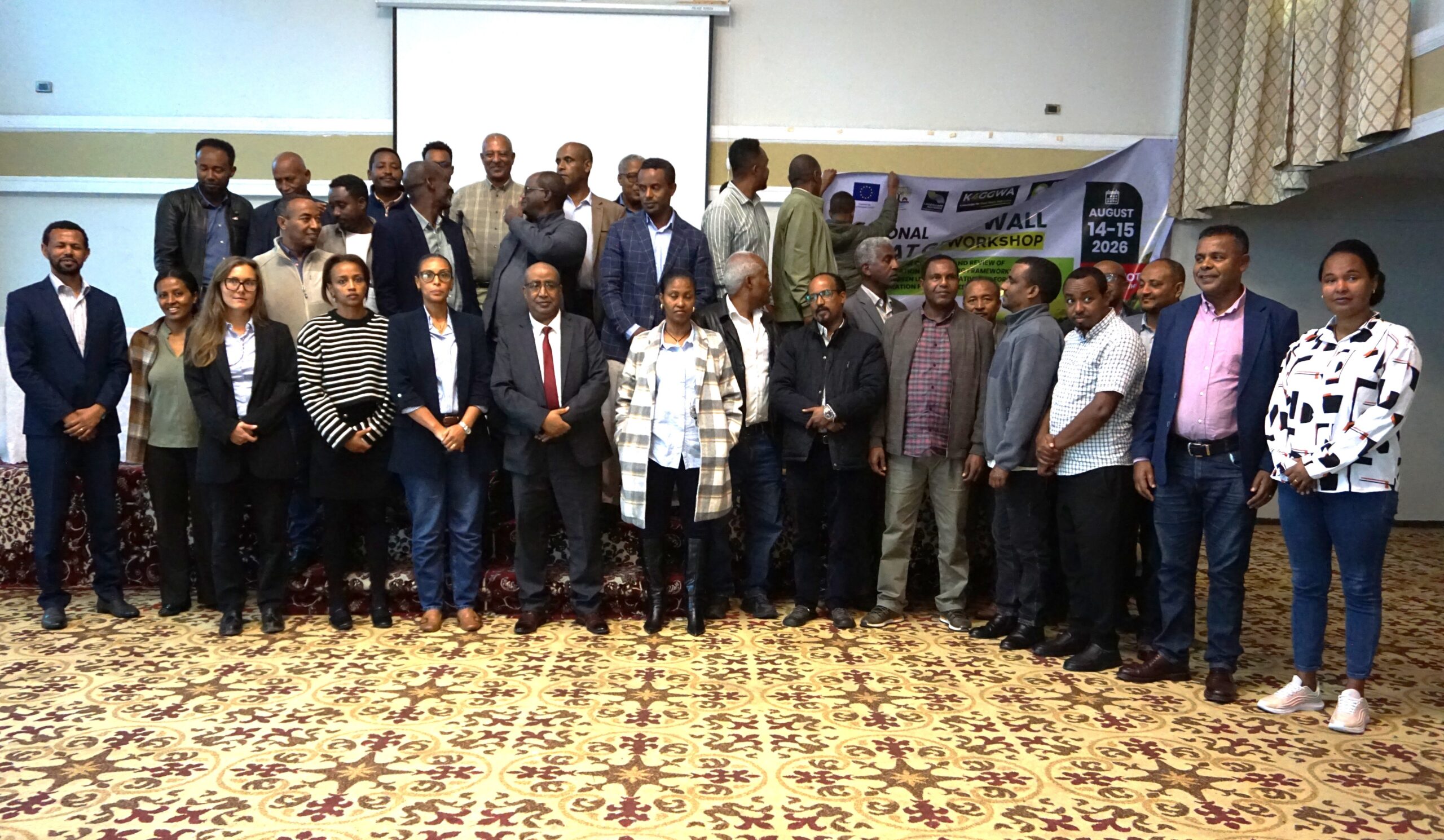 Participants at a Great Green Wall consultation workshop posing for a group photo indoors.