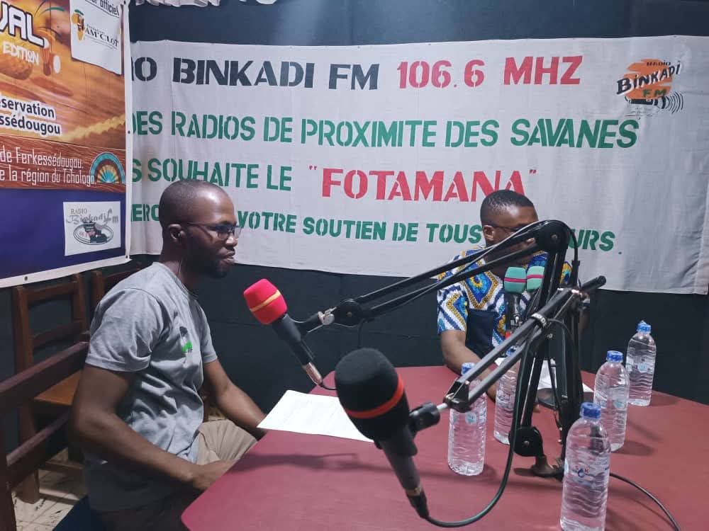 Two people take part in a radio programme at Bin Kadi FM.