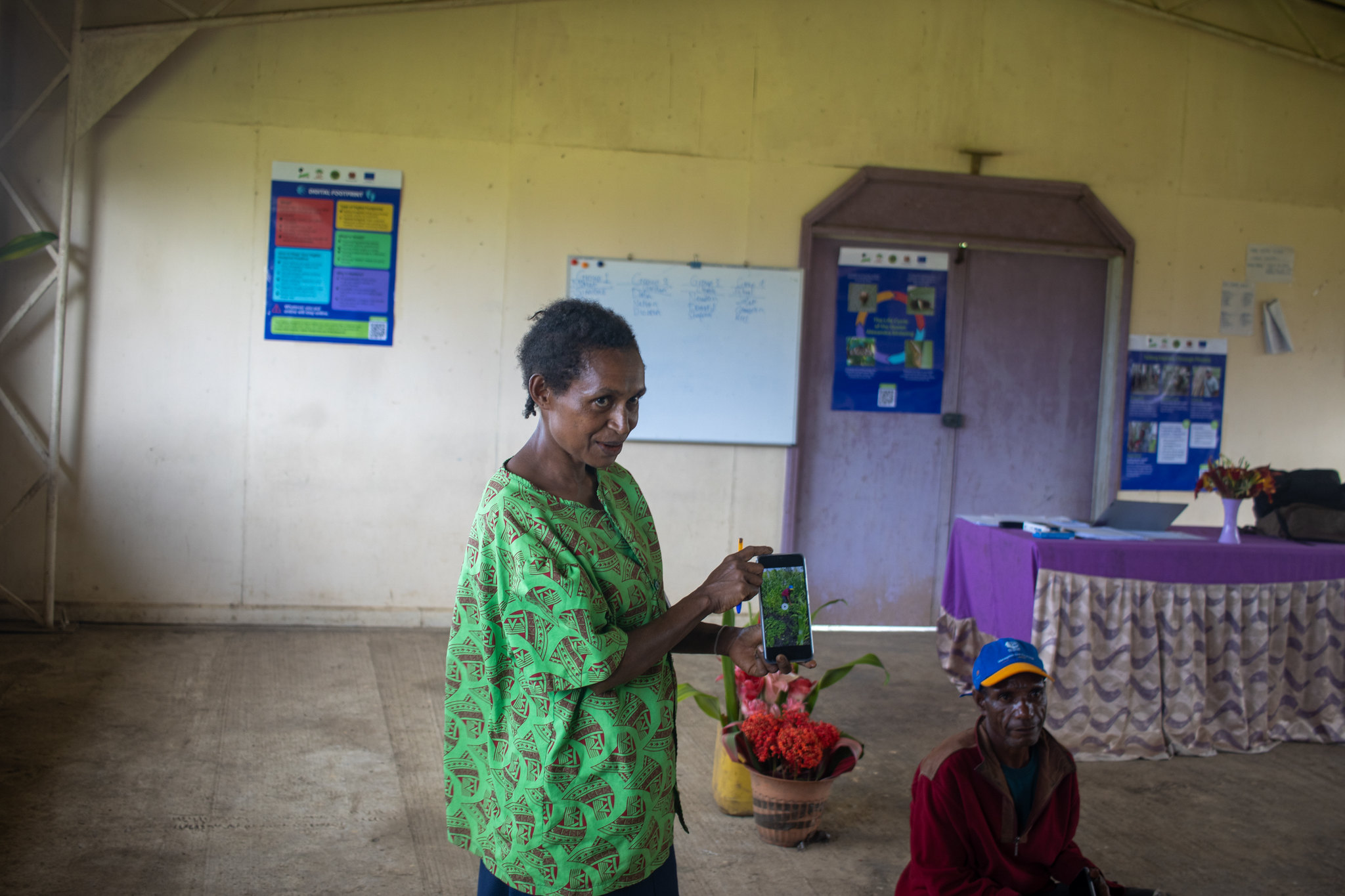 A participant presents a video story on vegetable gardening to other participants during a social media workshop.