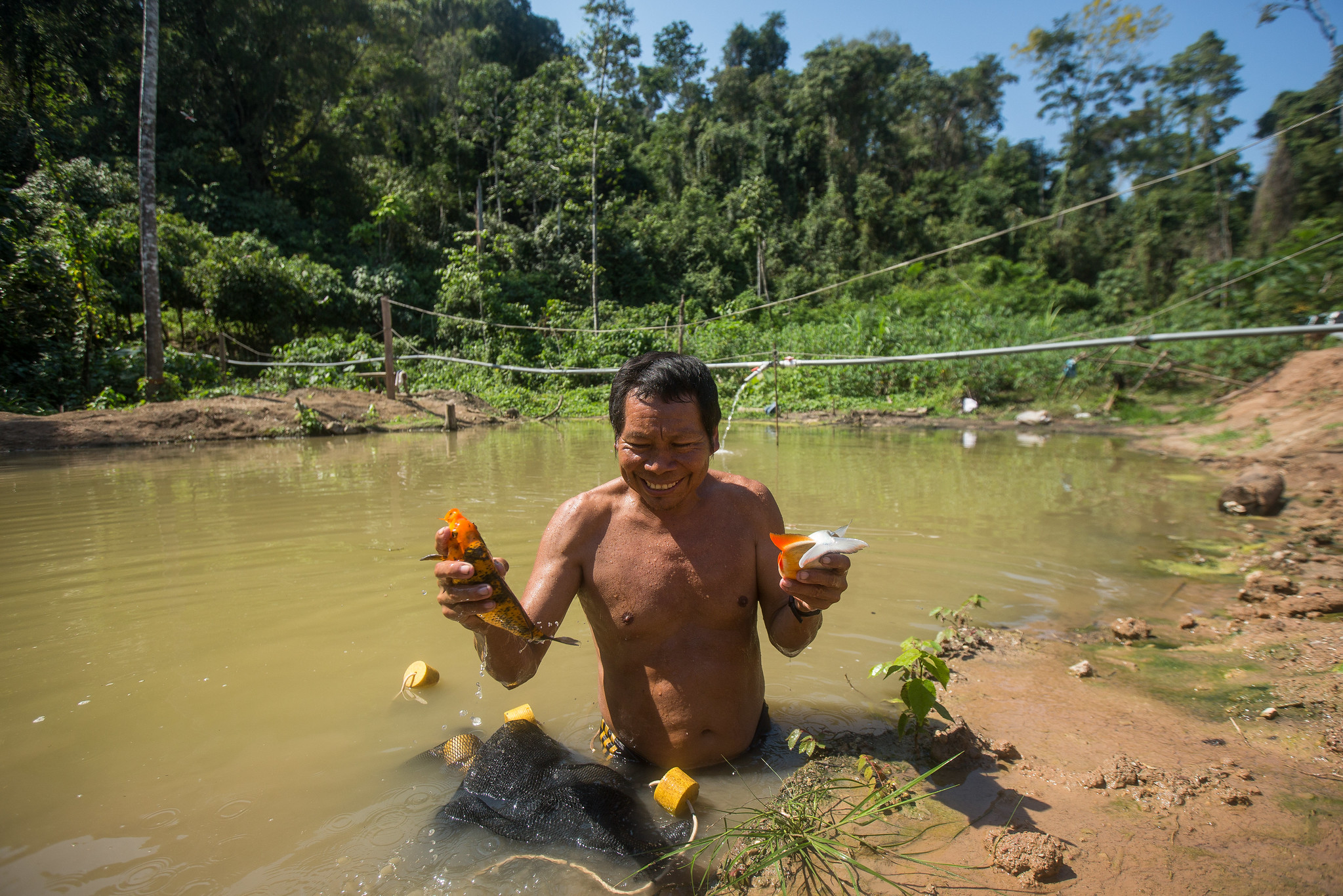 Man fishing in a shallow river in the Peruvian Amazon