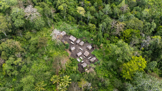 Aerial view of a small hamlet surrounded by dense tropical forest in the Managalas Conservation Area, illustrating the communities at the heart of inclusive forest governance and finance.