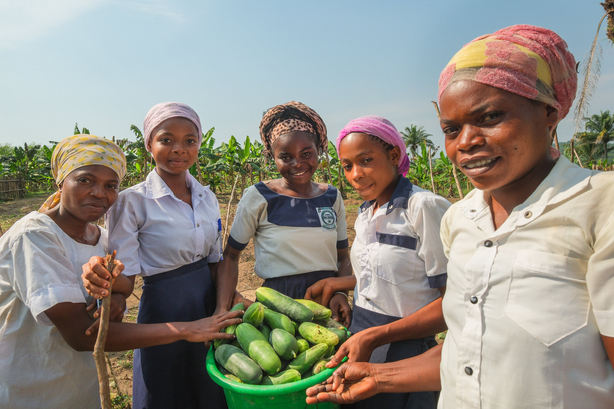 Students holding freshly harvested vegetables in a school garden in Yangambi, DR Congo