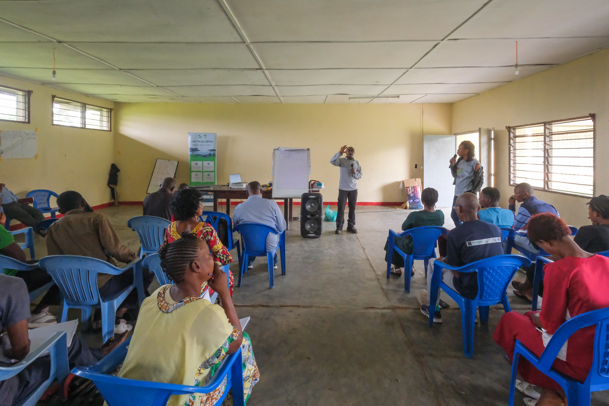 Participants listen to a presentation during a NutriScapes workshop on nutrition and food systems in Yangambi, Democratic Republic of the Congo.