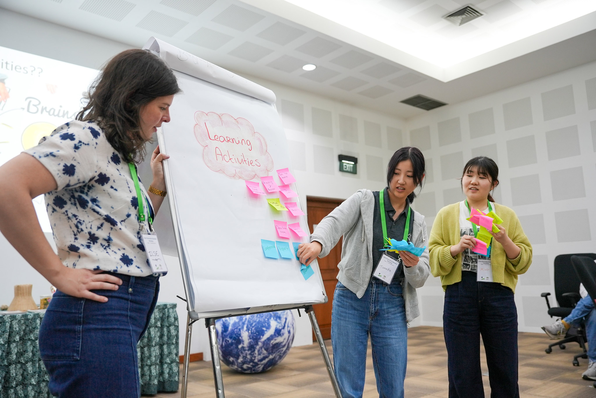 Ilse Hennemann and participants working around a flipchart with notes during a restoration education workshop at CIFOR-ICRAF Bogor campus.