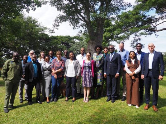 Group of researchers, policymakers and development practitioners from Southern Africa standing outdoors during the RAENS annual meeting in Lusaka, Zambia.