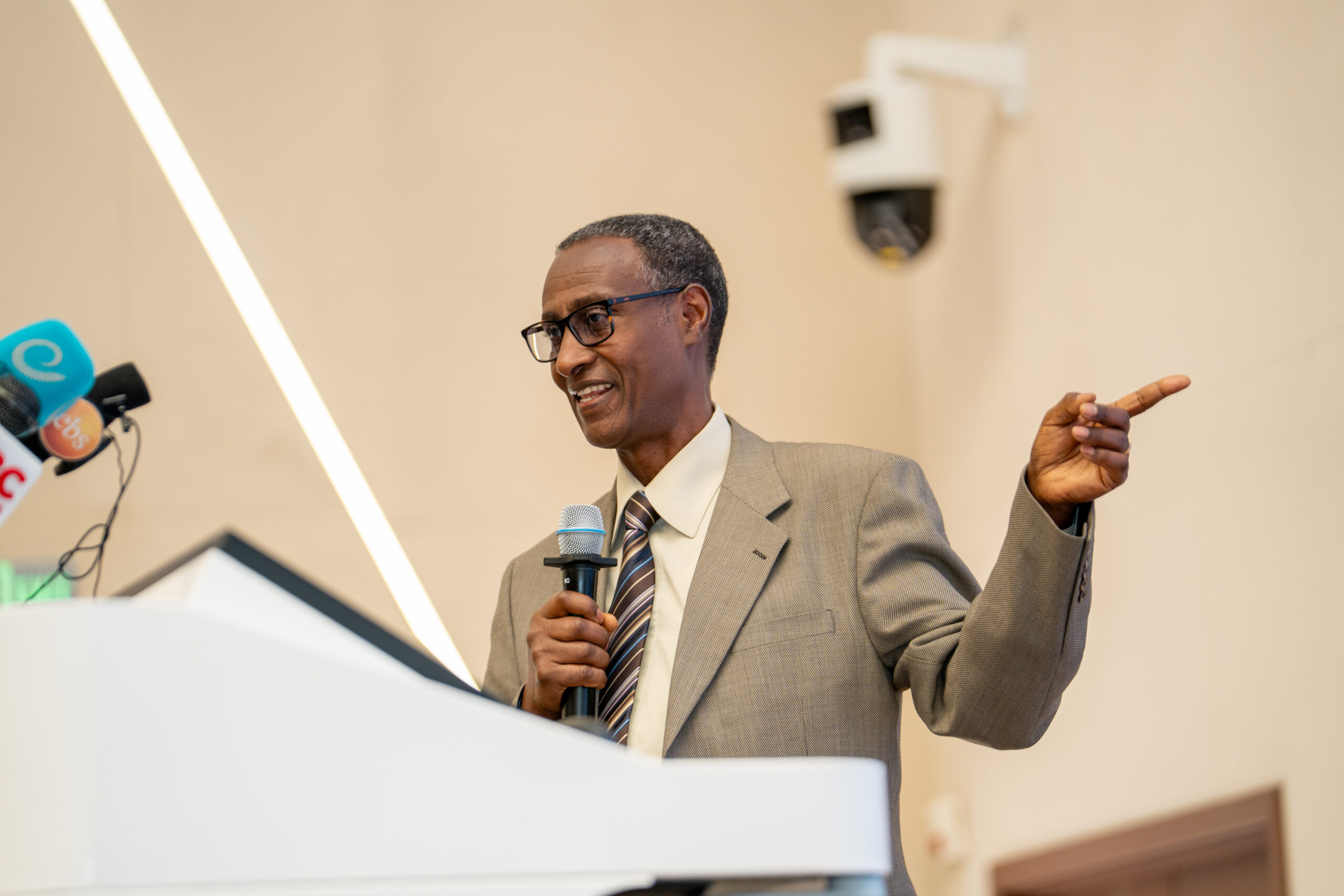 CIFOR-ICRAF scientist Endalkachew Wolde-Meskel speaking at a podium during the launch event in Addis Ababa