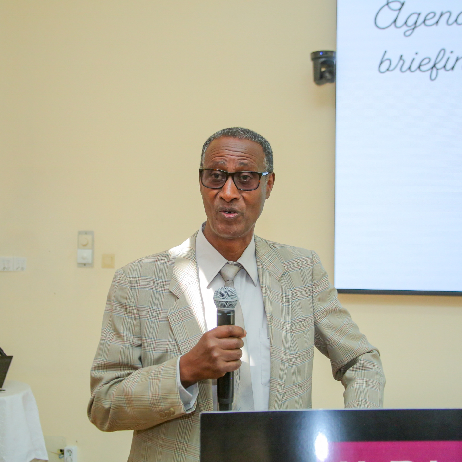 Dr. Endalkachew Wolde-Meskel speaks into a microphone during the national validation workshop for Ethiopia’s National Agroecology Strategy in Addis Ababa.