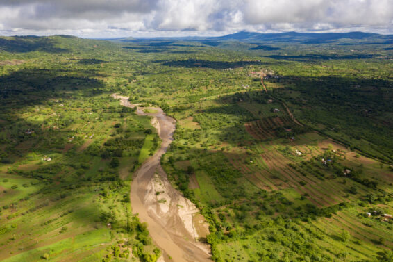 Aerial landscape in Kenya showing farmland, vegetation patterns and riverbeds used to assess soil and land health for restoration.