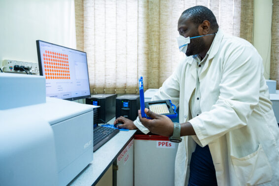 Technician analysing soil samples with spectroscopy equipment for soil prediction and landscape restoration.