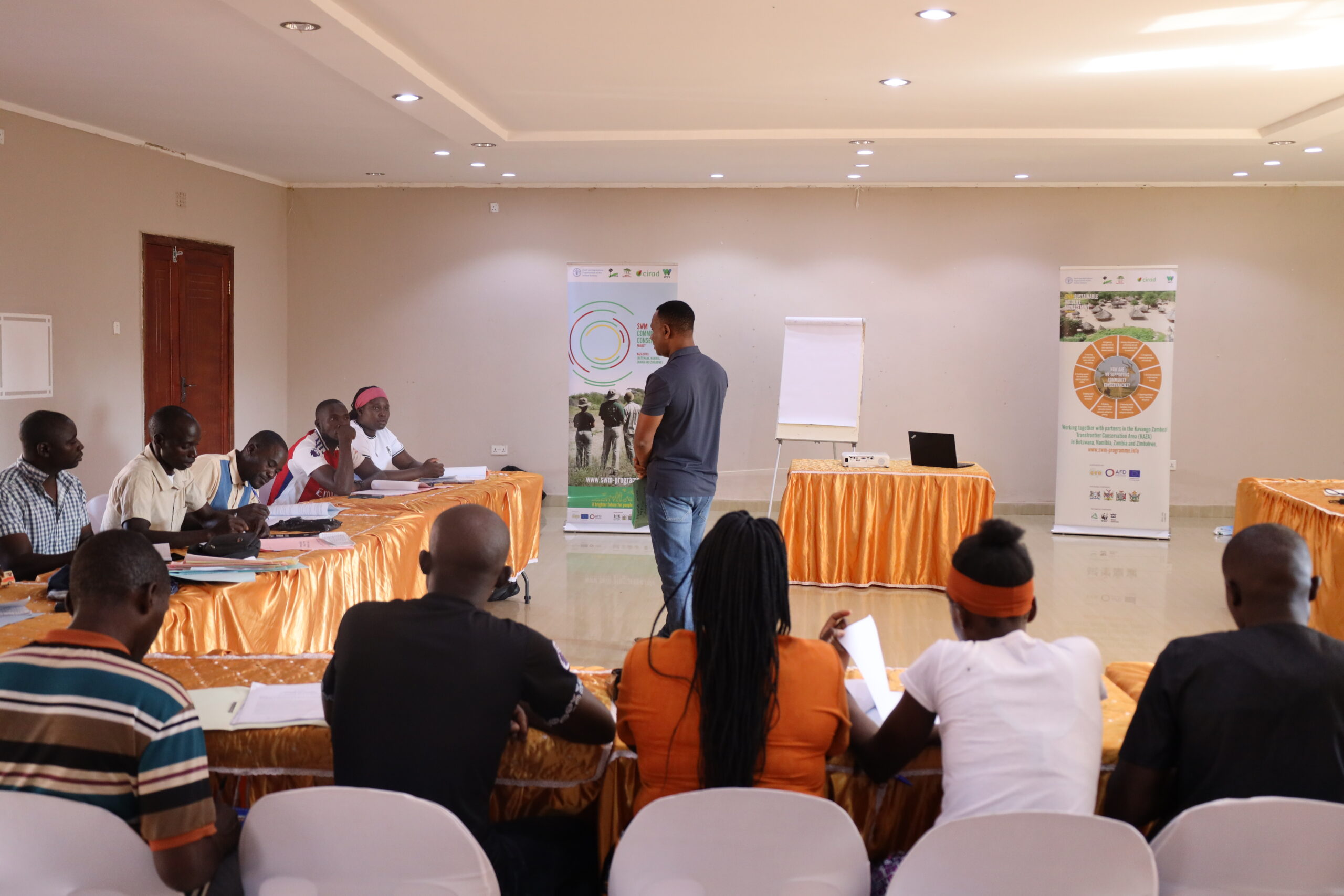 Trainer pointing to a flip chart during enterprise development training.