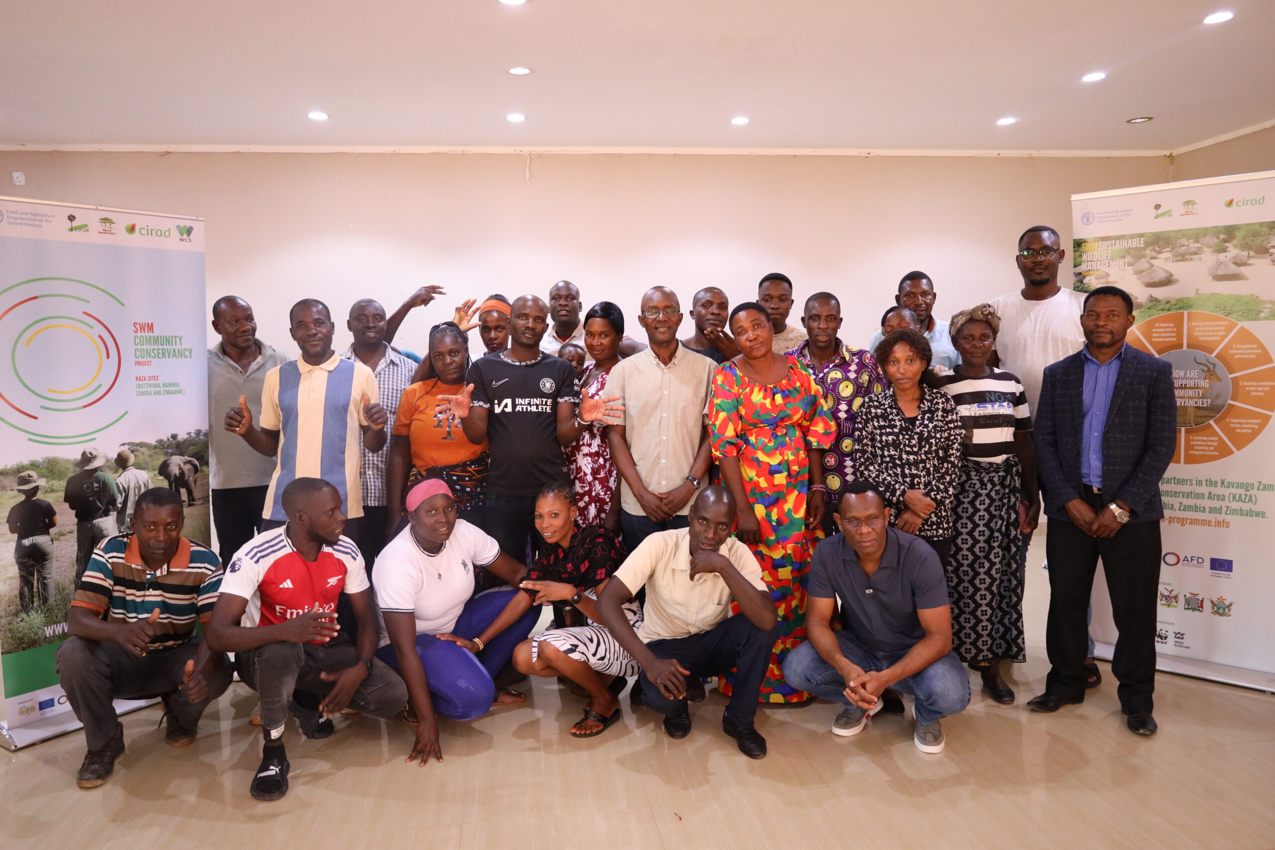 Group of cooperative members and trainers posing for a photo after a workshop.