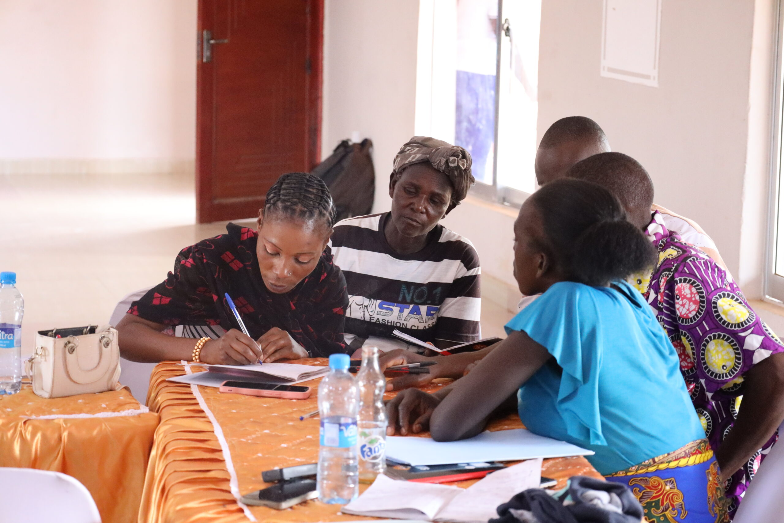 Group of cooperative members and trainers posing for a photo after a workshop.