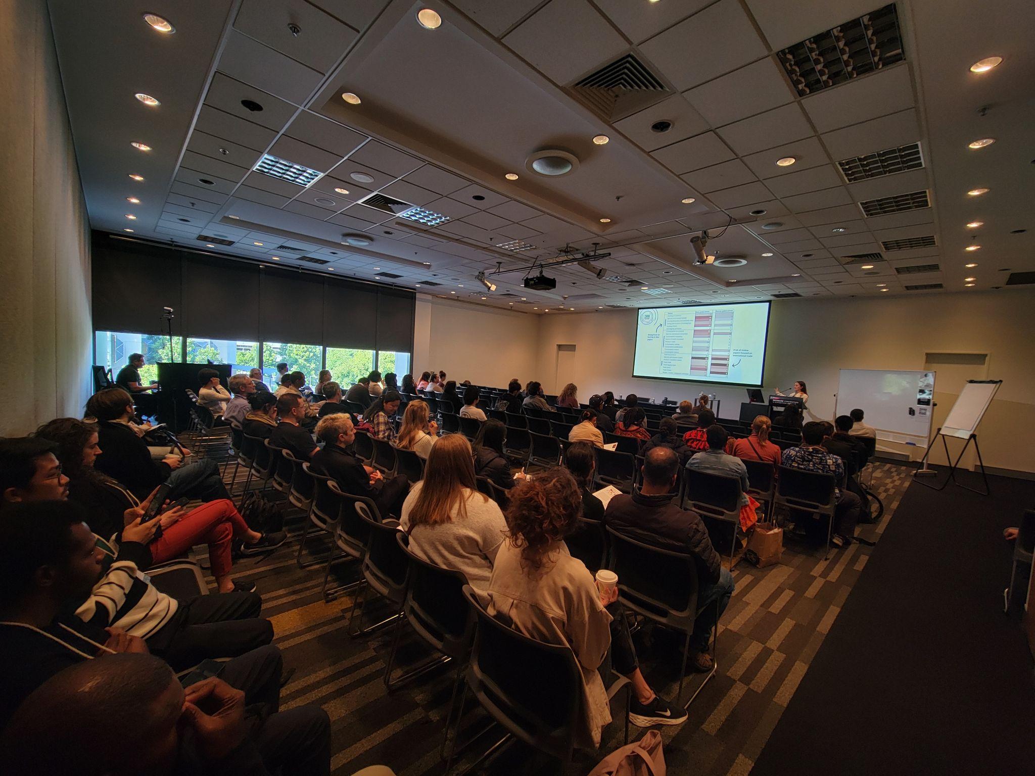 Audience seated in a conference room during the “From forest to fork” ICCB 2025 session, watching a presentation on wild meat value chains.