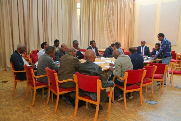 Workshop participants gathered around a table engaging in group discussions on Ethiopia’s National Agroecology Strategy.